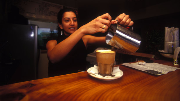 A barista displaying for skill at a Brisbane cafe.