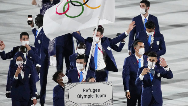 Yusra Mardini and Tachlowini Gabriyesos, of the Refugee Olympic Team, carry the Olympic flag during the Tokyo opening ceremony in the Olympic Stadium on Friday.