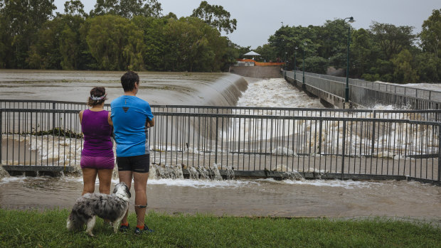 Locals observe floodwaters at Black Weir in Townsville.