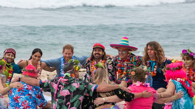 Prince Harry and Meghan, Duchess of Sussex sit on the sand with ‘Anti-bad-vibe circle’ local surfing community group, known as OneWave, raising awareness for mental health and wellbeing in a fun and engaging way at Bondi Beach.