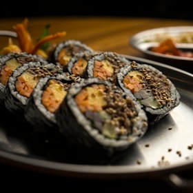 Kimbap rice rolls with bulgogi beef and perilla leaves.