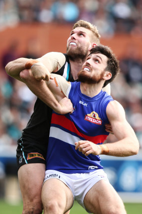 Jackson Trengove of the Power competes in the ruck with Tom Campbell.