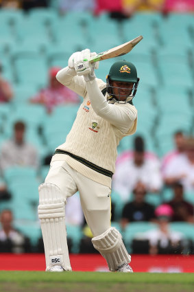 Usman Khawaja drives through covers.