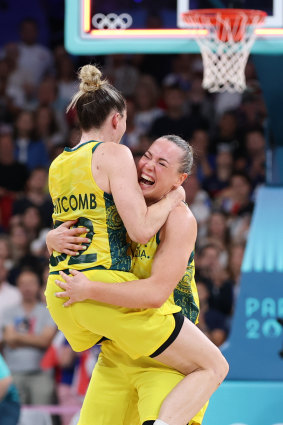 Australian Opals defenders Sammy Whitcomb (#32) and Tess Madgen (#7) celebrate the win over France.