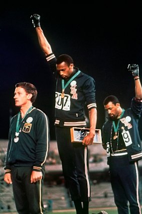 US athletes Tommie Smith and John Carlos, with Australia's Peter Norman, in their famous pose at the 1968 Games in Mexico. 