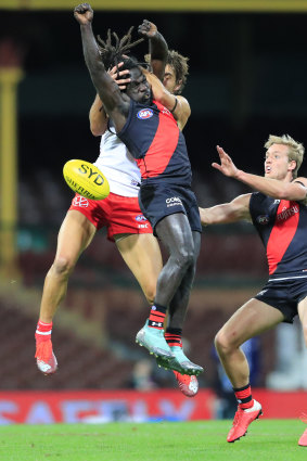 Anthony McDonald-Tipungwuti and the Swans' Josh Kennedy contest the ball.