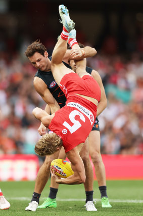 Heeney completes his extraordinary mark over the Giants’ Jack Buckley.