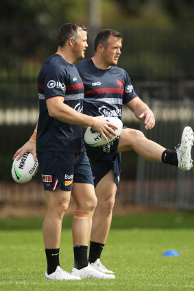 Josh Morris (right) and twin Brett enjoy a kick at Roosters training on Thursday.