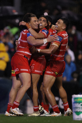 Dragons players celebrate Tyrell Sloan’s try.