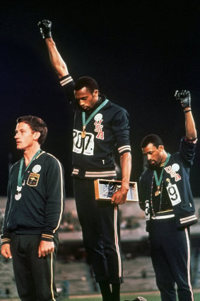 Peter Norman, left, stands next to Tommie Smith and John Carlos in Mexico.