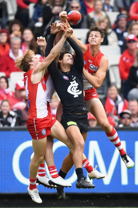 Callum Sinclair of the Swans spoils a mark by Jack Silvagni of the Blues.