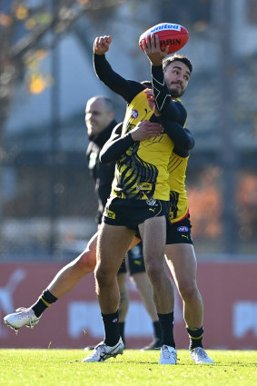 Shane Edwards handballs while being tackled.