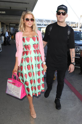 Berry nice: Paris Hilton, with fiance Chris Zylka, wears a Michelle Torres dress at LAX. 