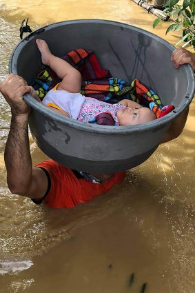 A baby is rescued from a flooded village in the Cagayan valley, northern Philippines on Friday.