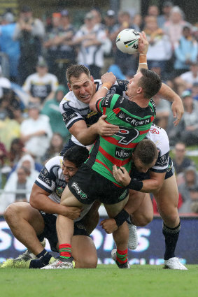 Damien Cook is tackled by the Cowboys on Sunday.