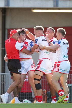 Cody Ramsay (second from left) celebrates with teammates after one of two tries he scored on his debut.