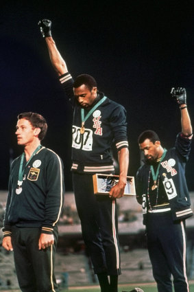 US athletes Tommie Smith and John Carlos, with Australia's Peter Norman, in their famous pose at the 1968 Games in Mexico. 