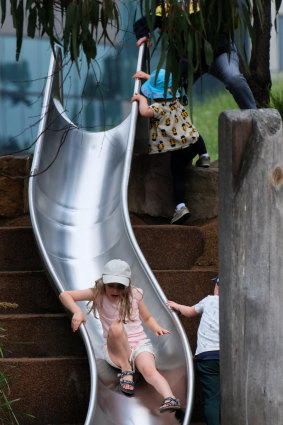 A girl plays on a slide at the Royal Park Nature Playground. 