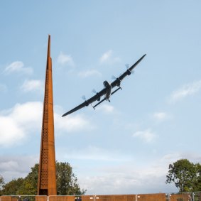 Lancaster bomber flying past International Bomber Command Centre.
