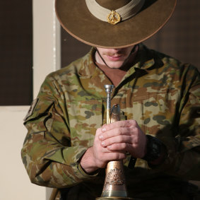 An Australian bugler plays the Last Post in Taji, Iraq, 2016.