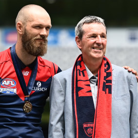 Max Gawn and Neale Daniher stand on stage together during the Demons’ long-awaited AFL premiership celebration at the MCG in December.