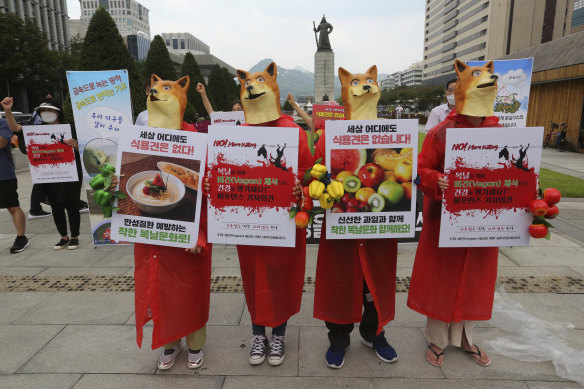 South Korean vegetarian activists wearing dog masks stage a rally opposing South Korea’s culture of eating dog meat in Seoul in 2020.