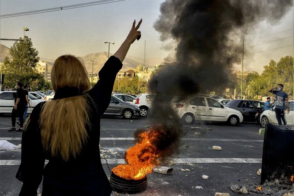 Iranians protests the death of 22-year-old Mahsa Amini after she was detained by the morality police, in Tehran, October.