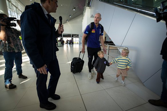 Brennan Cox arrives with his two young children.