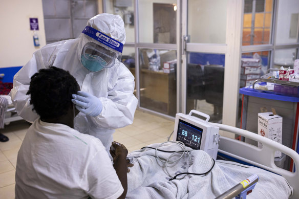 A nurse checks a COVID patient in the intensive care unit in Machakos, Kenya. 