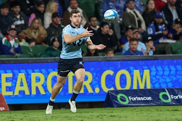Lawson Creighton of the NSW Waratahs passes the ball