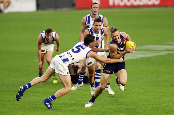 Nat Fyfe looks to avoid North’s Curtis Taylor in Fremantle’s win on Saturday night.
