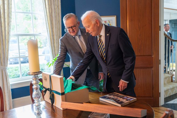 Albanese and Biden exchange gifts.