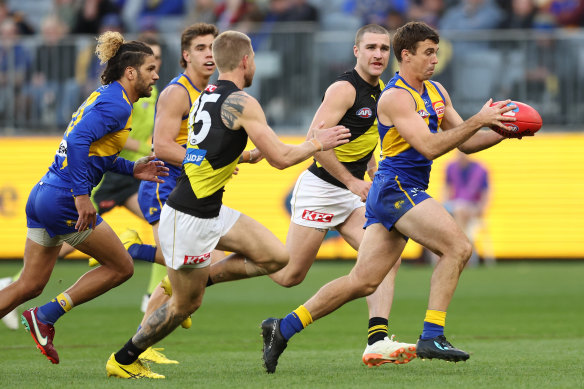 Tigers tacklers converge on West Coast’s Jamie Cripps.
