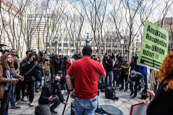 An Amazon labor organiser speaks to members of the media during the vote count.