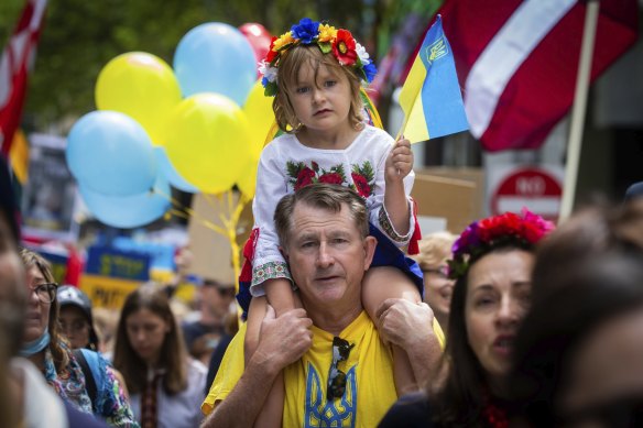 Jaroslav Koptchak marches on Sunday with his four-year-old daughter Margaret.