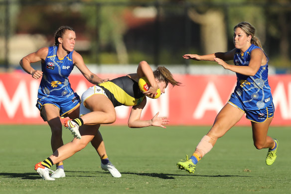 Maddy Brancatisano of the Tigers is tackled by Emma Swanson of the Eagles during the 2022 AFLW Round 07 match between the West Coast Eagles and the Richmond Tigers at Mineral Resources Park on February 19, 2022 In Perth, Australia.
