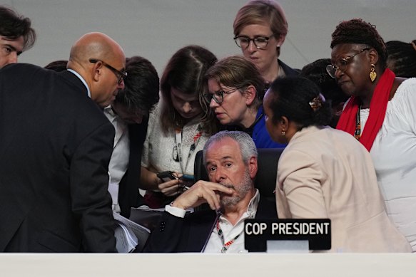 André Corrêa do Lago, COP30 president, sits as Simon Stiell, UN climate chief (left) speaks with other UN officials during a plenary session at the COP30 meeting.