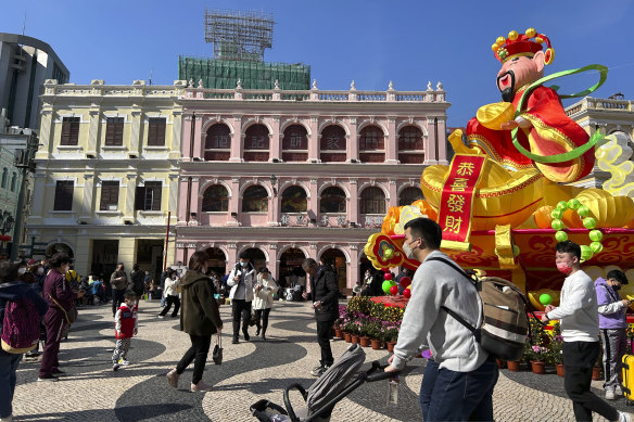Travellers from mainland China walk around Senado Square, a tourist destination in Macao, on Wednesday.