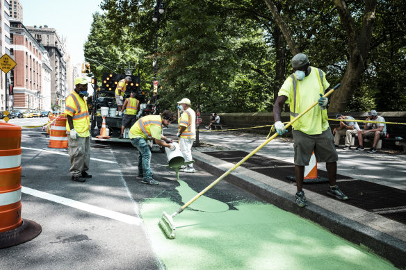 Workers prepare a new protected bike lane along Central Park West in Manhattan, near where Australian Madison Jane Lyden was killed on a bike.