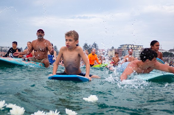 People splash the water to celebrate the life of Nico Antic.
