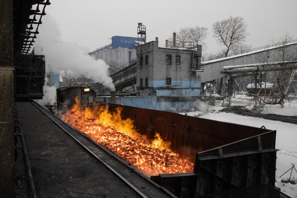Flames rise from red hot coal ahead of cooling at the Moscow coal and gas plant, operated by Mechel PJSC, in Vidnoye, near Moscow, Russia. 