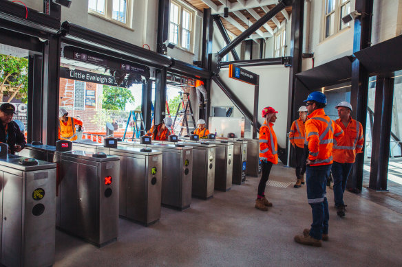 Workers put the finishing touches to the  new station entrance on Little Eveleigh Street. 