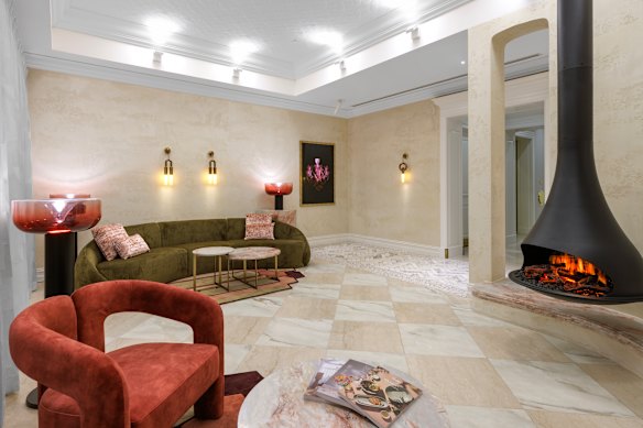 Guests go to a lounge area with a hanging fireplace for an informal check-in.
