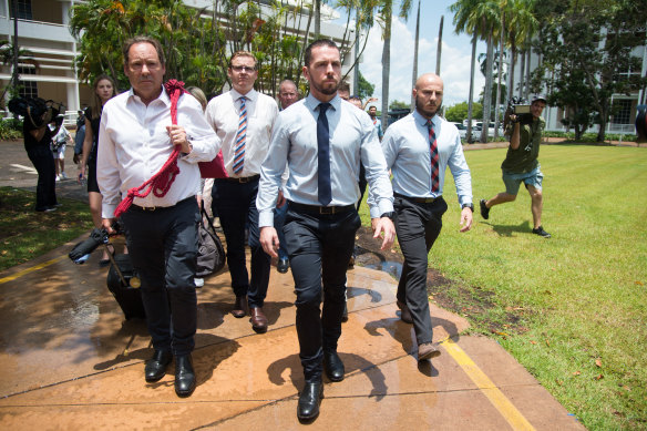 Constable Zachary Rolfe (centre) leaves the Northern Territory Supreme Court on Friday. 