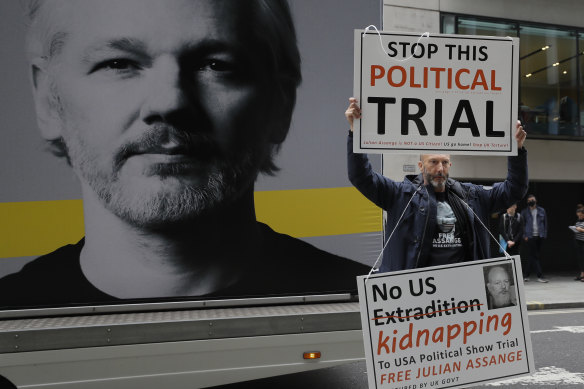 A demonstrator holds placards in support of Julian Assange near the Old Bailey in London this week.