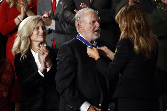 Rush Limbaugh, centre, receives the Medal of Freedom from US first lady Melania Trump during Donald Trump's 2020 State of the Union address.