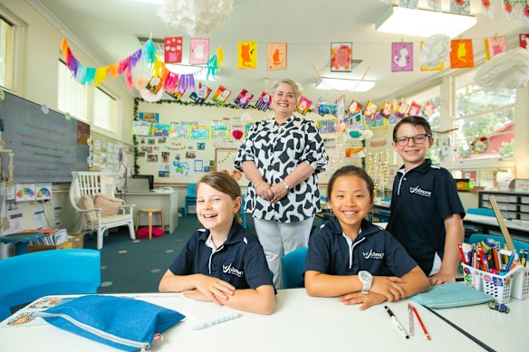 Golda Paparo, 8, Amelia Trinh, 7, and Leopold Boyatzis, 8, with Jolimont Primary School principal Barbara Iffla.