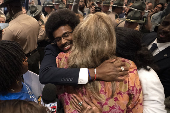 Former Representative Justin Pearson, left, Representative Gloria Johnson, centre and former Representative Justin Jones embrace outside the House chamber after Pearson and Jones were expelled.