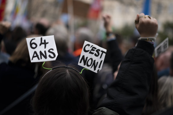 A protester wears a sign on her hairband reading “64 years, no way” during a demonstration in Marseille on Saturday.