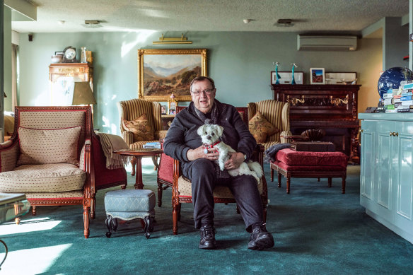 Harold Mitchell in his Melbourne apartment with his dog Lily.